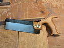 an 8 inch american kid saw with brass fasteners and a cherry handle