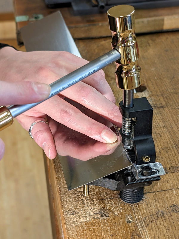 Bad axe tool works hammer saw set in use with a brass set hammer